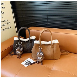 Detail of winter tote bags with faux fur trim, plush charms, and adjustable shoulder straps