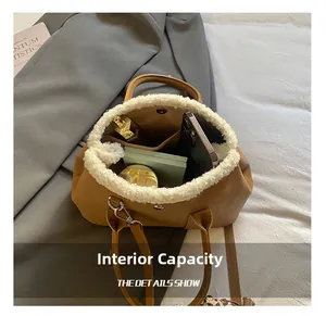 Interior view of brown leather bucket bag showing capacity for phone and cosmetics