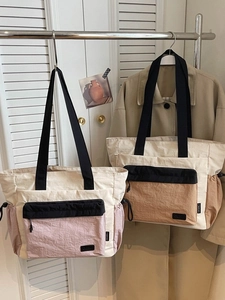 Stylish nylon tote bags for travel and fitness featuring contrast color stitching and straps