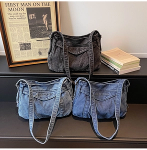 Close-up of three color vintage denim tote bags with embroidery and washed texture