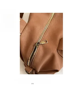 Close-up of retro bronze metal zipper and smooth texture on brown leather handbag