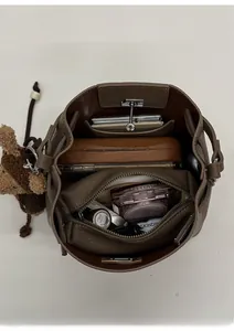 Interior view of the brown leather bucket bag showing large capacity for cosmetics