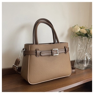 Détail du sac bandoulière en tissu marron avec poignées cuir et boucle métal argent