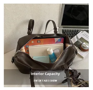 Macro detail of the spacious internal capacity in the dark brown leather tote bag