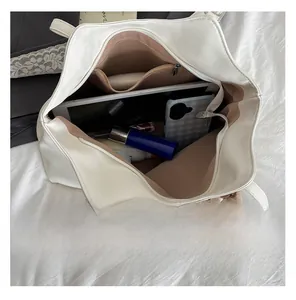 Top view of the white leather tote bag interior showing large storage space and pockets