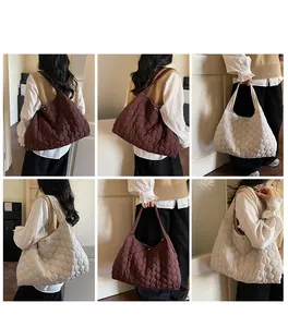 Detail view of quilted puffer tote bags in brown and beige with magnetic snap closure
