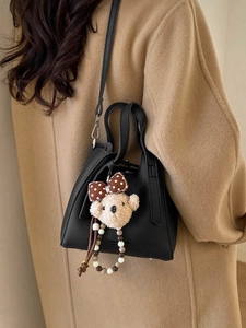 Minimalist black lychee texture bucket bag with a cute plush bear pendant accessory
