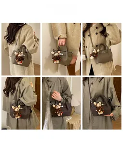 Detail shots of fashionable bucket bag with metal buckle and cute bear pendant charm