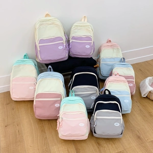 Detailed comparison of colorful macaron backpacks in multiple sizes and pastel color block designs