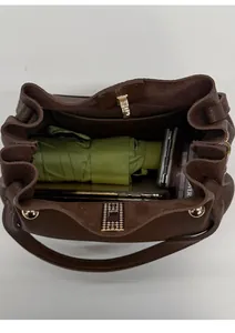 Top view of brown leather bucket bag showing inner space for phone, umbrella and makeup