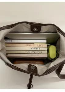 Top view of large tote bag interior showing spacious storage with laptop and books