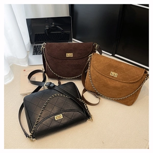 Nahaufnahme gesteppter Ledertaschen mit goldener Kette und Metalldrehverschluss in drei Farben