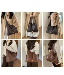 Detail of minimalist tote bag with contrast stitching and metal ring buckle on leather