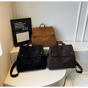 Detailed view of matte texture backpacks in black, brown and dark coffee colors