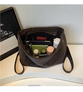 Top view of large brown matte tote bag showing spacious interior with multiple items