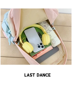 Detailed internal view showing organized storage of books and phone in macaron backpack