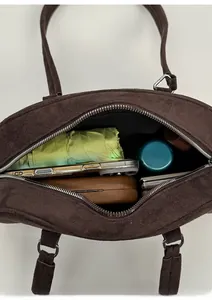 Top view of brown suede Boston bag showing large interior capacity for daily essentials