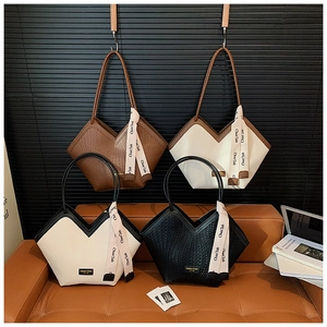 Detailed view of large woven tote bags in four colors with stylish decorative ribbons