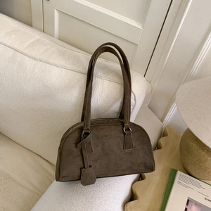 Detail of vintage chocolate brown suede boston bag with long shoulder straps and soft texture