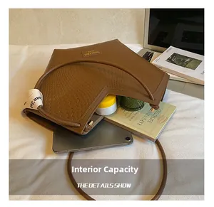 Detailed view of brown woven tote bag interior showing large capacity for laptop and books