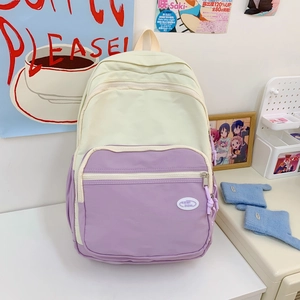 Detail of macaron pastel backpack featuring cream and lavender waterproof nylon fabric