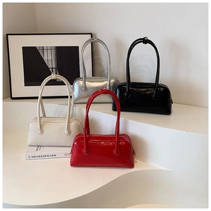 Group display of shiny patent leather Boston bags in white, silver, black, and red colors