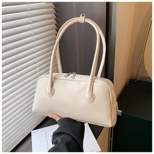 Detail of cream PU leather handbag featuring dual zippers and embossed brand logo