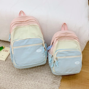 Macro view of macaron patchwork backpacks showing multi-pocket design and fabric texture