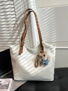 Minimalist white faux leather tote bag with brown straps and cute bear pendant charm