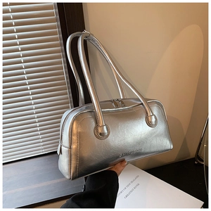 Detail of silver metallic leather Boston bag featuring natural pleated texture and handles