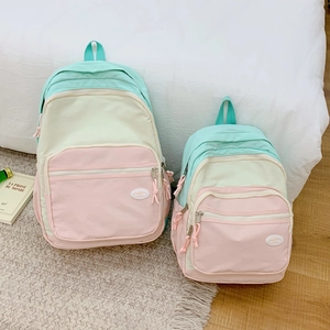 Detail view of macaron color-block canvas backpacks in two sizes for family or travel