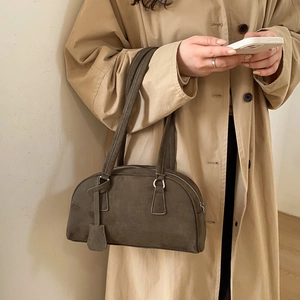 Detail of vintage dark brown suede Boston bag with silver zipper and dual long handles