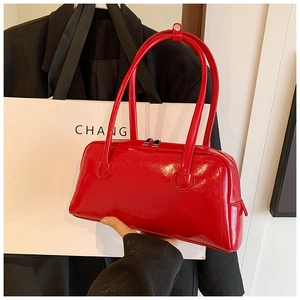 Close-up of red glossy leather tote bag with SHIYUBAG embossed logo and long handles