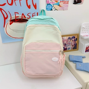 Macro detail of macaron pastel patchwork backpack with nylon texture and front logo label