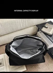 Internal capacity display of a black waterproof crossbody bag with light grey lining