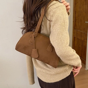Detail of vintage brown suede Boston bag showing soft texture and shoulder strap