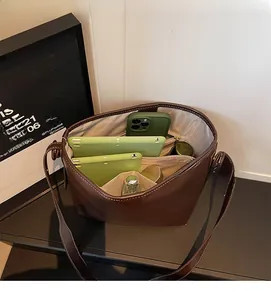 Interior view of brown bucket bag showing multiple compartments and spacious storage