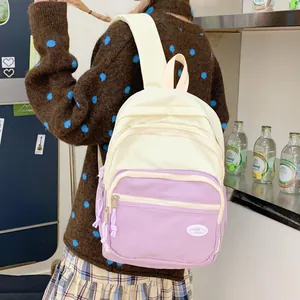 Detail of multi-pocket macaron backpack in cream and lilac with adjustable straps