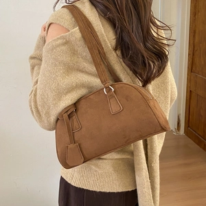 Detail of vintage matte leather Boston bag showing brown suede texture and shoulder straps