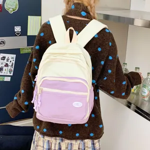 Back view of a macaron colorblock backpack on a model showing size and comfort