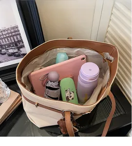 Spacious interior of beige canvas tote bag showing tablet and daily essentials