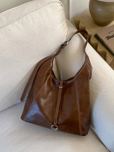 Minimalist large brown tote bag with white contrast stitching and silver metal buckle
