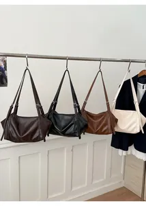 Detail of four vintage tote bags in dark brown, black, caramel and off-white finishes