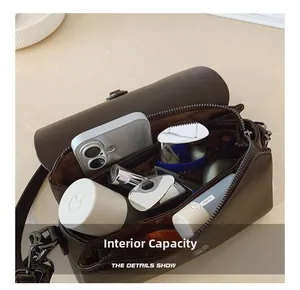 Top-down view of spacious inner compartments and pockets in dark brown leather crossbody bag