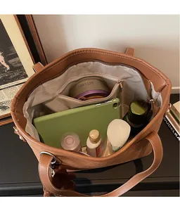 Top view of large canvas tote bag showing spacious interior with leather trim details