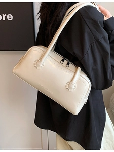 Chic beige Boston bag in vegan leather with top handles and shoulder strap for daily use
