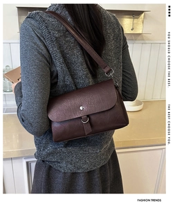 Detail of the litchi texture and metal ring closure on this vintage brown leather bag