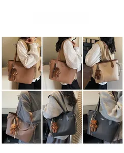 Detail view of multi-color litchi grain tote bags with cute brown bear plush pendant