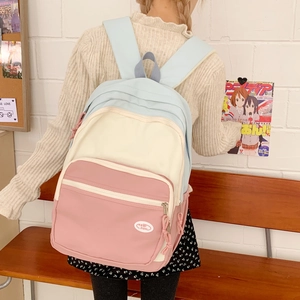 Detailed back view of a tricolor pastel backpack with soft pink blue and white panels