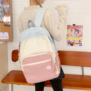 Close-up of pastel macaron color-block backpack with durable nylon fabric and wide straps
